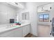 Bright bathroom with double sinks, white cabinets, and colorful accent towels at 10646 E Butherus Dr, Scottsdale, AZ 85255