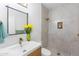 Modern bathroom featuring sleek vanity with gold faucet, large mirror, and tiled shower with niche at 10646 E Butherus Dr, Scottsdale, AZ 85255