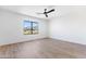 Bright bedroom with a ceiling fan, hardwood floors, and large window with beautiful mountain views at 10646 E Butherus Dr, Scottsdale, AZ 85255
