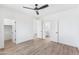 Bright bedroom with wood floors features ceiling fan and multiple doorways at 10646 E Butherus Dr, Scottsdale, AZ 85255