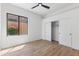 Bedroom featuring wood floors, a large window with a view, and a closet with sliding doors at 10646 E Butherus Dr, Scottsdale, AZ 85255