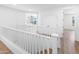 Hallway features wood flooring, white walls, and doorways leading to various rooms at 10646 E Butherus Dr, Scottsdale, AZ 85255
