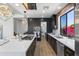 Modern kitchen featuring an island, breakfast bar, stainless steel appliances, and stylish pendant lighting at 10646 E Butherus Dr, Scottsdale, AZ 85255