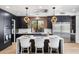 Stylish kitchen features sleek black cabinetry, white countertops, and a bright window overlooking lush greenery at 10646 E Butherus Dr, Scottsdale, AZ 85255