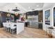 Modern kitchen boasts stainless steel appliances, a large island with seating, and stylish pendant lighting at 10646 E Butherus Dr, Scottsdale, AZ 85255
