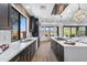 Spacious kitchen with stainless steel appliances, quartz countertops, and natural light from large windows at 10646 E Butherus Dr, Scottsdale, AZ 85255