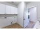 Spacious laundry room with white cabinets, washer/dryer hookups, and modern design at 10646 E Butherus Dr, Scottsdale, AZ 85255