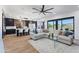 Open-concept living space with a modern kitchen, comfortable seating, and large windows offering scenic views at 10646 E Butherus Dr, Scottsdale, AZ 85255
