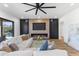 Bright living room featuring fireplace, ceiling fan, and large white sectional sofa at 10646 E Butherus Dr, Scottsdale, AZ 85255