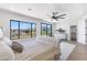 Bright main bedroom with scenic mountain views, ceiling fan, and tufted headboard at 10646 E Butherus Dr, Scottsdale, AZ 85255