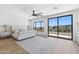 Bright main bedroom featuring a king bed, a ceiling fan, and exterior views at 10646 E Butherus Dr, Scottsdale, AZ 85255