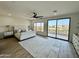 Luxurious main bedroom with private balcony and hardwood floors at 10646 E Butherus Dr, Scottsdale, AZ 85255