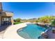 Inviting backyard pool with a spa, lush landscaping, and patio area for outdoor enjoyment at 10646 E Butherus Dr, Scottsdale, AZ 85255
