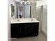 Bathroom with double vanity and dark wood cabinets at 44229 W Pioneer Rd, Maricopa, AZ 85139