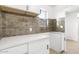 Modern white kitchen with quartz countertops and stylish backsplash at 749 W Southgate Ave, Phoenix, AZ 85041