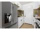 Modern kitchen with stainless steel appliances and white cabinets at 749 W Southgate Ave, Phoenix, AZ 85041