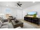 Living room with a large TV, comfy seating, and a modern coffee table at 749 W Southgate Ave, Phoenix, AZ 85041