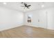 Well-lit spare bedroom with wood flooring and a door to the exterior at 749 W Southgate Ave, Phoenix, AZ 85041