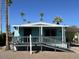 Charming single-wide mobile home with covered porch and ramp at 9501 E Broadway Rd # 165, Mesa, AZ 85208