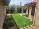 Charming backyard with a covered patio, lush lawn, and beautiful landscaping for outdoor enjoyment at 2164 S Catarina --, Mesa, AZ 85202