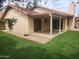 View of the home's exterior showcasing the backyard patio and lush lawn at 2164 S Catarina --, Mesa, AZ 85202