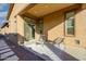 Inviting back patio featuring lounge chairs, decorative rug, and backyard access at 23461 N 76Th Pl, Scottsdale, AZ 85255