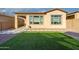 Well-maintained backyard with gravel and artificial turf, and a paver pathway at 23461 N 76Th Pl, Scottsdale, AZ 85255