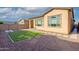 Backyard featuring gravel, artificial turf, and paver pathway leading to the home at 23461 N 76Th Pl, Scottsdale, AZ 85255
