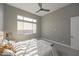 Well-lit bedroom offering neutral walls, plush carpet, and a modern ceiling fan at 23461 N 76Th Pl, Scottsdale, AZ 85255
