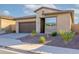 Charming single-story home featuring a desert landscape, stone accents, and a two-car garage at 23461 N 76Th Pl, Scottsdale, AZ 85255