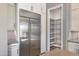 Close-up view of the gourmet kitchen's stainless steel refrigerator and walk-in pantry at 23461 N 76Th Pl, Scottsdale, AZ 85255