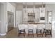 Stylish kitchen with a large island, pendant lighting, stainless steel appliances, and white cabinetry at 23461 N 76Th Pl, Scottsdale, AZ 85255
