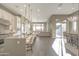 Spacious open floorplan with modern kitchen, living, and dining areas under recessed lighting at 23461 N 76Th Pl, Scottsdale, AZ 85255