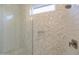 Modern glass enclosed shower with hexagon tile accent wall at 23461 N 76Th Pl, Scottsdale, AZ 85255