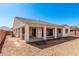 Rear exterior view of home featuring a covered patio, tile roof, and desert landscaping potential at 5214 W Rainwater Dr, Laveen, AZ 85339