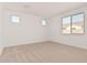 Bright bedroom featuring plush carpet, neutral paint, and multiple windows for natural light at 5214 W Rainwater Dr, Laveen, AZ 85339