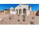 The home's exterior features an elegant facade, stucco, and a well-manicured desert landscape at 5214 W Rainwater Dr, Laveen, AZ 85339