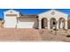 Beautiful exterior with a two-car garage, decorative details, and stunning brick driveway at 5214 W Rainwater Dr, Laveen, AZ 85339