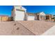 Stunning exterior showcases a spacious three-car garage and decorative brick driveway at 5214 W Rainwater Dr, Laveen, AZ 85339