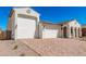 Beautiful house exterior featuring a three-car garage and stunning brick driveway at 5214 W Rainwater Dr, Laveen, AZ 85339