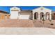 Charming single-story home with a three-car garage and a brick driveway at 5214 W Rainwater Dr, Laveen, AZ 85339