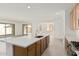 Spacious kitchen with quartz countertops, stainless appliances, and island seating at 5214 W Rainwater Dr, Laveen, AZ 85339