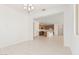 Spacious open-concept living room leading to a kitchen with a large island and ample lighting at 5214 W Rainwater Dr, Laveen, AZ 85339