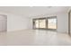 Spacious living room featuring tile flooring, neutral paint, and sliding glass doors at 5214 W Rainwater Dr, Laveen, AZ 85339