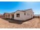 Rear exterior with covered patio and tiled roof, ready for personalization with landscaping at 5214 W Rainwater Dr, Laveen, AZ 85339
