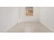 Empty room showcases tile flooring and a bright window at 5214 W Rainwater Dr, Laveen, AZ 85339