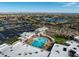 Overhead view of a large pool area with lounge chairs, surrounded by green spaces, parking and views of the city at 16001 W Huron Dr, Sun City West, AZ 85375