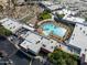 Aerial view of a recreational facility with a unique pool, mini golf, parking, green spaces and multiple buildings at 16001 W Huron Dr, Sun City West, AZ 85375