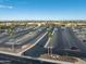 Spacious parking lot with desert landscaping in front of a building with mountain views under a clear, blue sky at 16001 W Huron Dr, Sun City West, AZ 85375