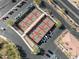 Aerial view of pickleball courts with shade structures, surrounded by parking and mature trees at 16001 W Huron Dr, Sun City West, AZ 85375